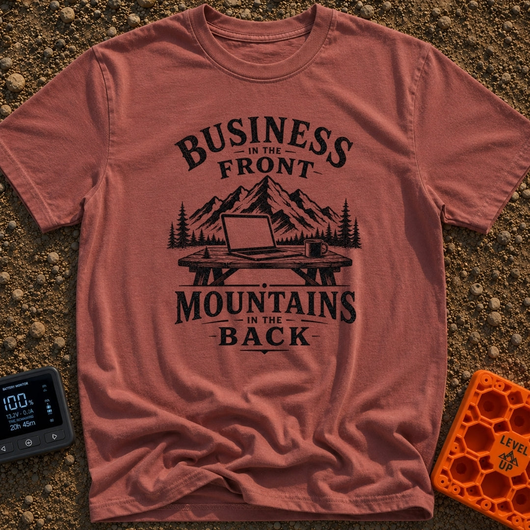 Working From Roam - T-Shirt in Brick - A black and white illustration of an open laptop and a mug sitting on a wooden...