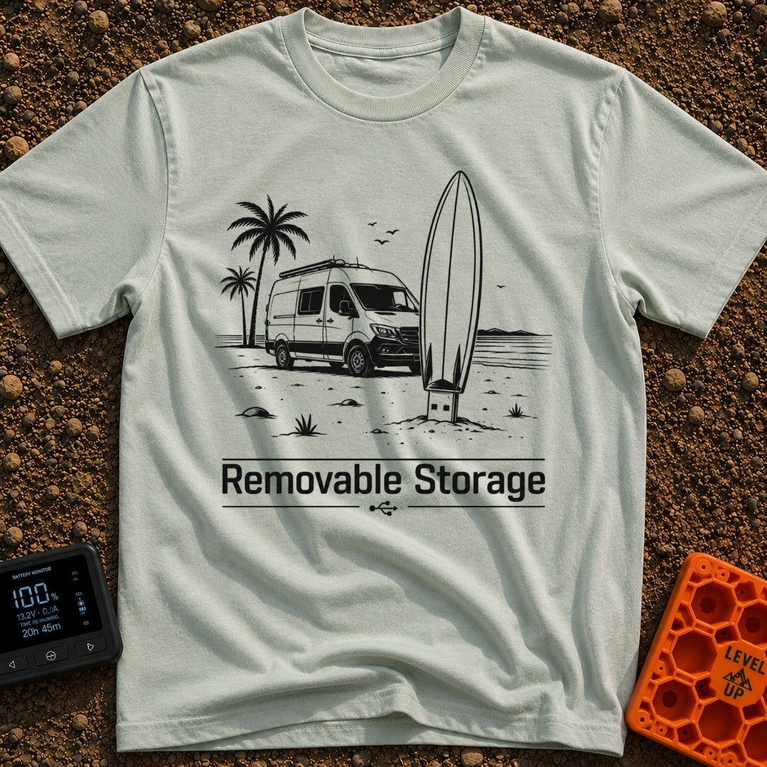 External Surf Drive - T-Shirt in Bay - A black and white illustration of a camper van parked on a beach with palm trees...
