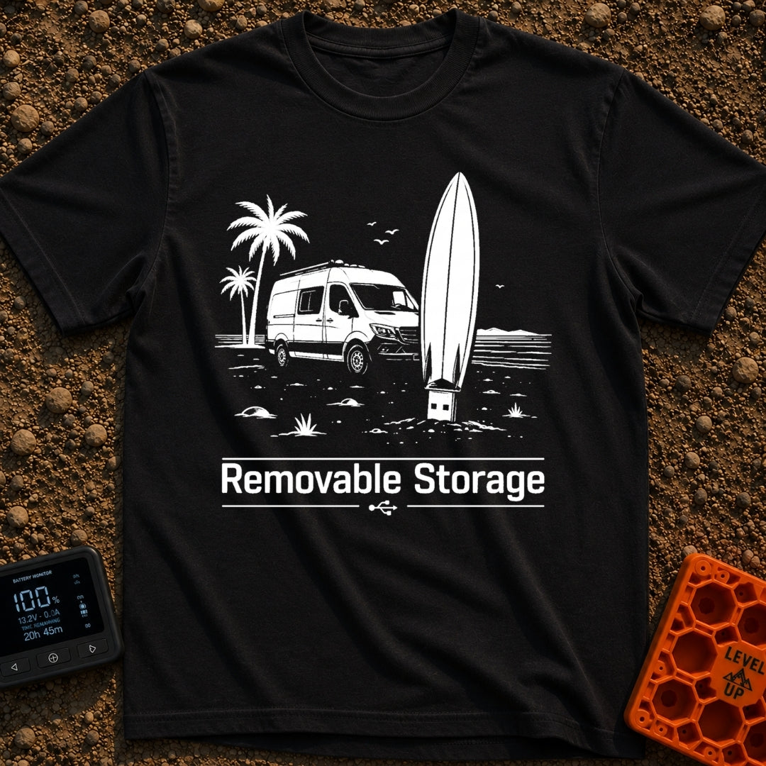 External Surf Drive - T-Shirt in Black - A black and white illustration of a camper van parked on a beach with palm trees...