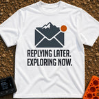 Reply Later Explore Now - T-Shirt in White - A graphic of a dark grey email envelope where the top flap is shaped like a...
