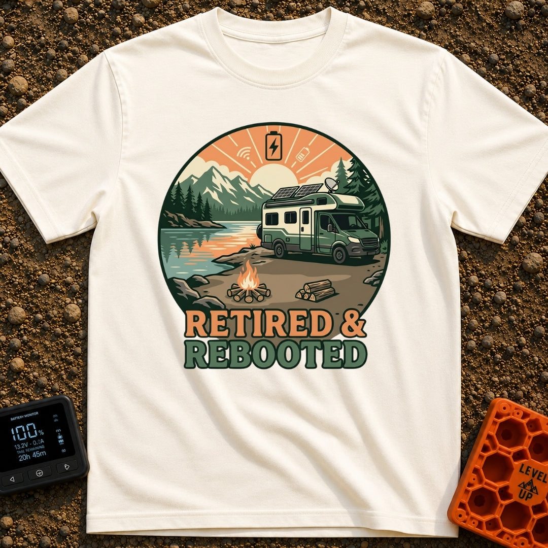 Retired and Rebooted - T-Shirt in Ivory - A circular illustration of a green and white RV parked beside a mountain lake...