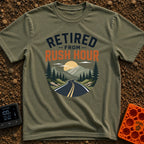 Beat The Rush - T-Shirt in Moss - Text reading "RETIRED FROM RUSH HOUR" above a circular landscape illustration of an...