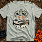 Retired But Recharged - T-Shirt in Bay - A graphic badge depicting a white campervan parked in a mountainous landscape at...