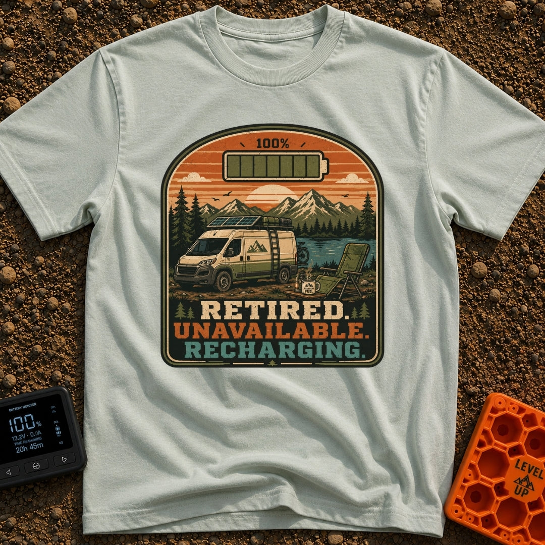 Retired And Recharging - T-Shirt in Bay - A camper van equipped with roof-mounted solar panels is parked at a scenic...