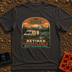 Retired And Recharging - T-Shirt in Graphite - A camper van equipped with roof-mounted solar panels is parked at a scenic...
