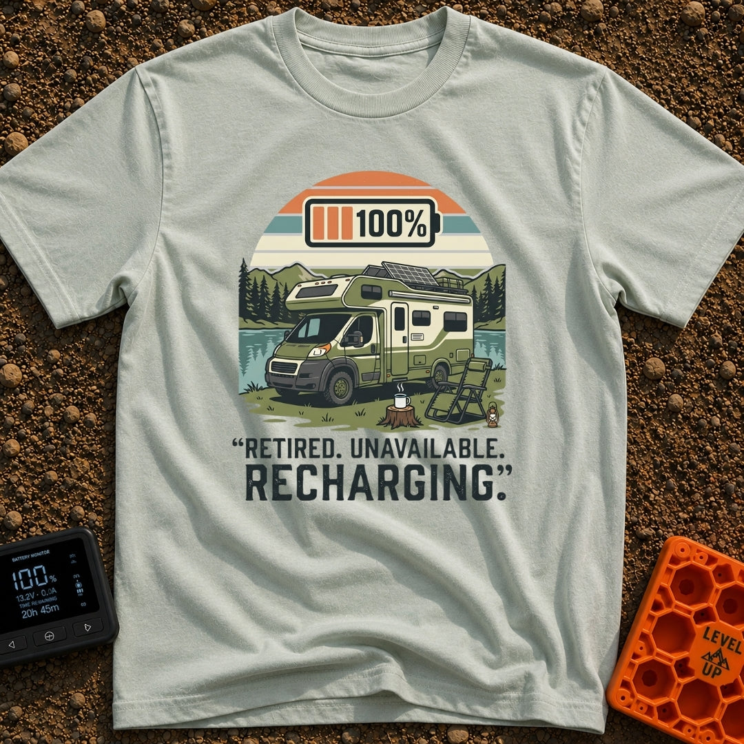 Retired And Recharging - T-Shirt in Bay - A green Class C camper van with rooftop solar panels is parked by a lake and...