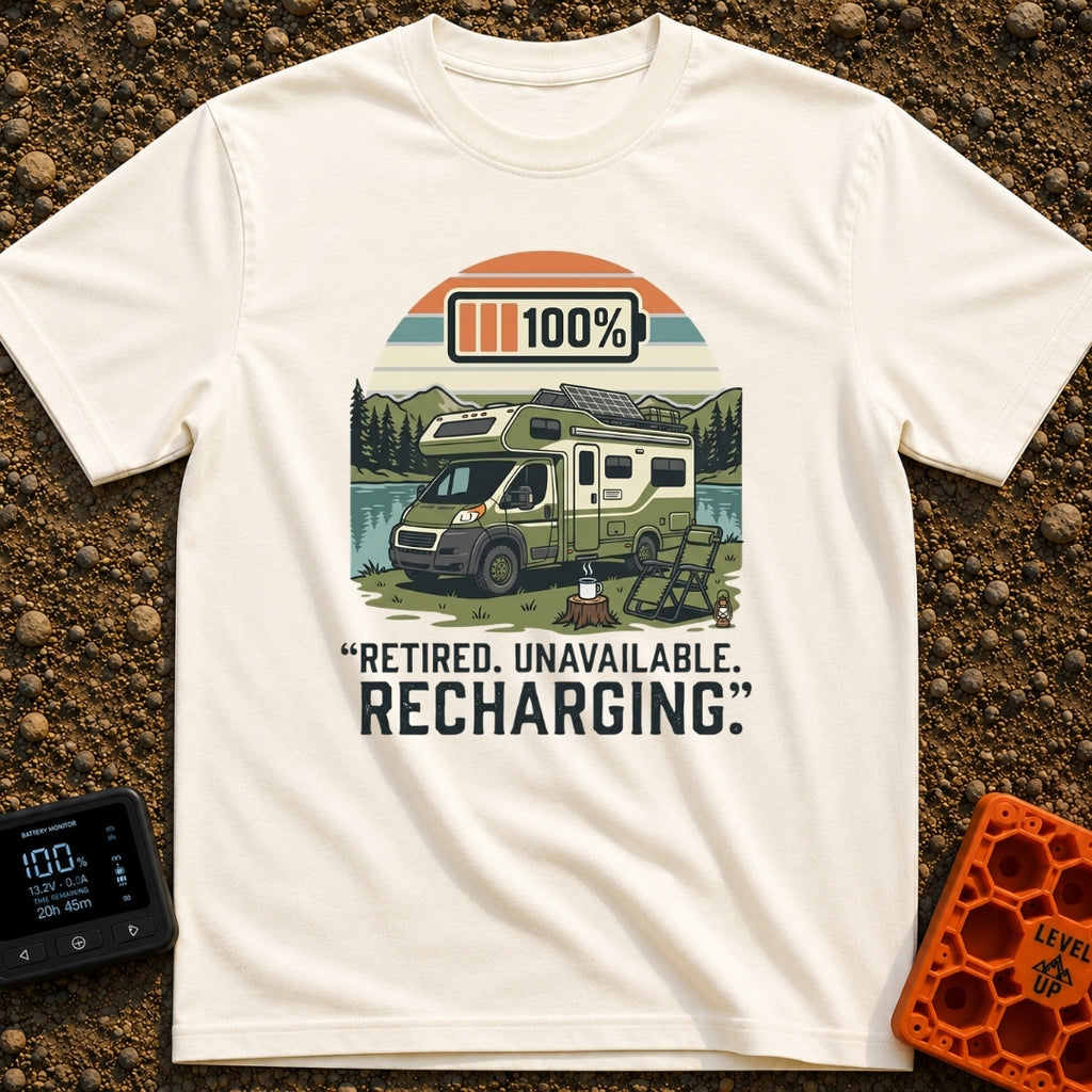 Retired And Recharging - T-Shirt in Ivory - A green Class C camper van with rooftop solar panels is parked by a lake and...