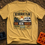 Retire Van Vanish - T-Shirt in Mustard - A graphic badge design showing a white camper van parked beside a lake and...