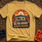 Wired In The Wild - T-Shirt in Mustard - A retro-style motorhome with a large solar panel on its roof drives along a...