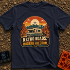 Wired In The Wild - T-Shirt in Navy - A retro-style motorhome with a large solar panel on its roof drives along a winding...