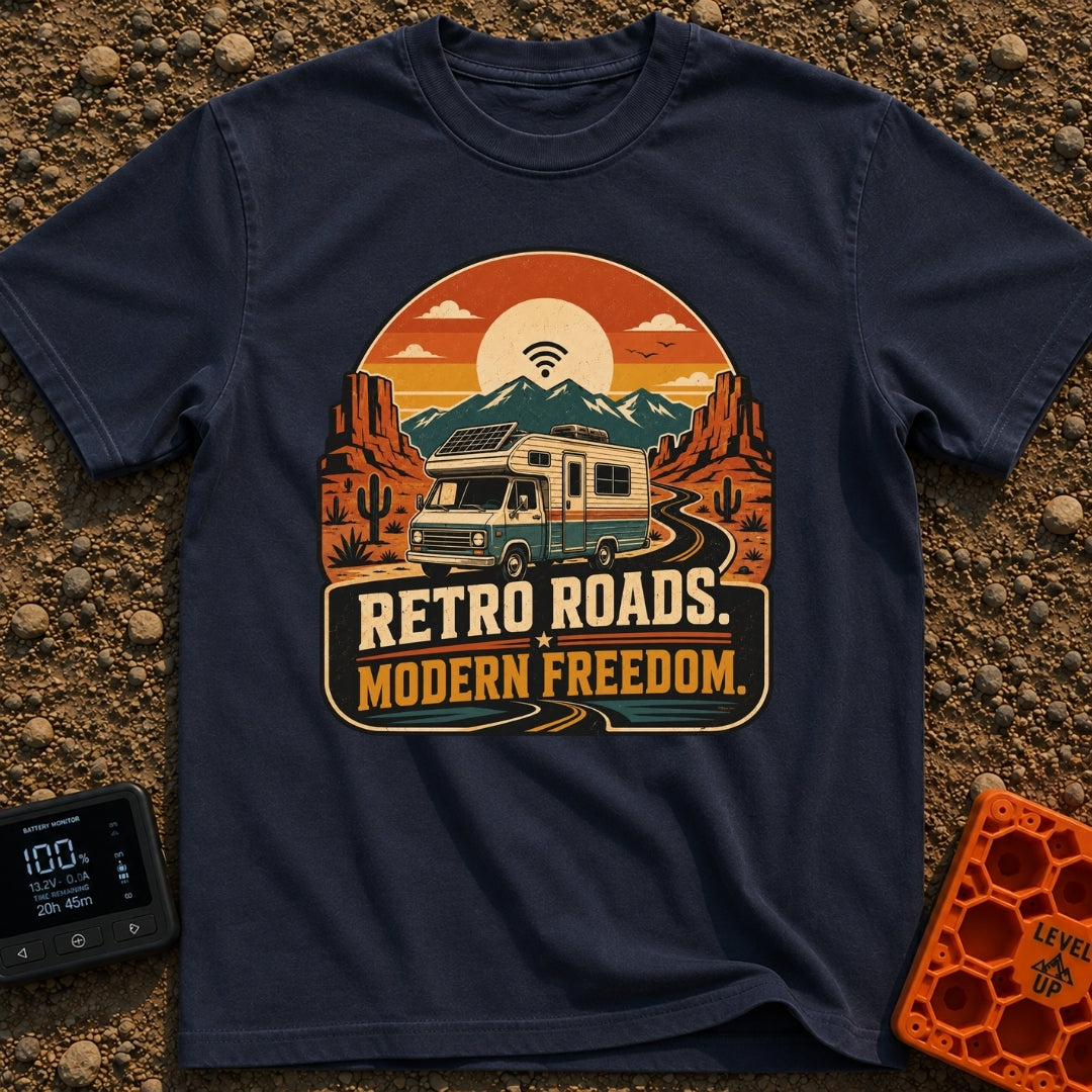 Wired In The Wild - T-Shirt in Navy - A retro-style motorhome with a large solar panel on its roof drives along a winding...
