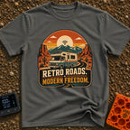 Wired In The Wild - T-Shirt in Pepper - A retro-style motorhome with a large solar panel on its roof drives along a...
