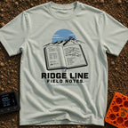 Ridge Top Chronicles - T-Shirt in Bay - An open notebook showing GPS coordinates, tyre pressure logs, a mountain sketch,...