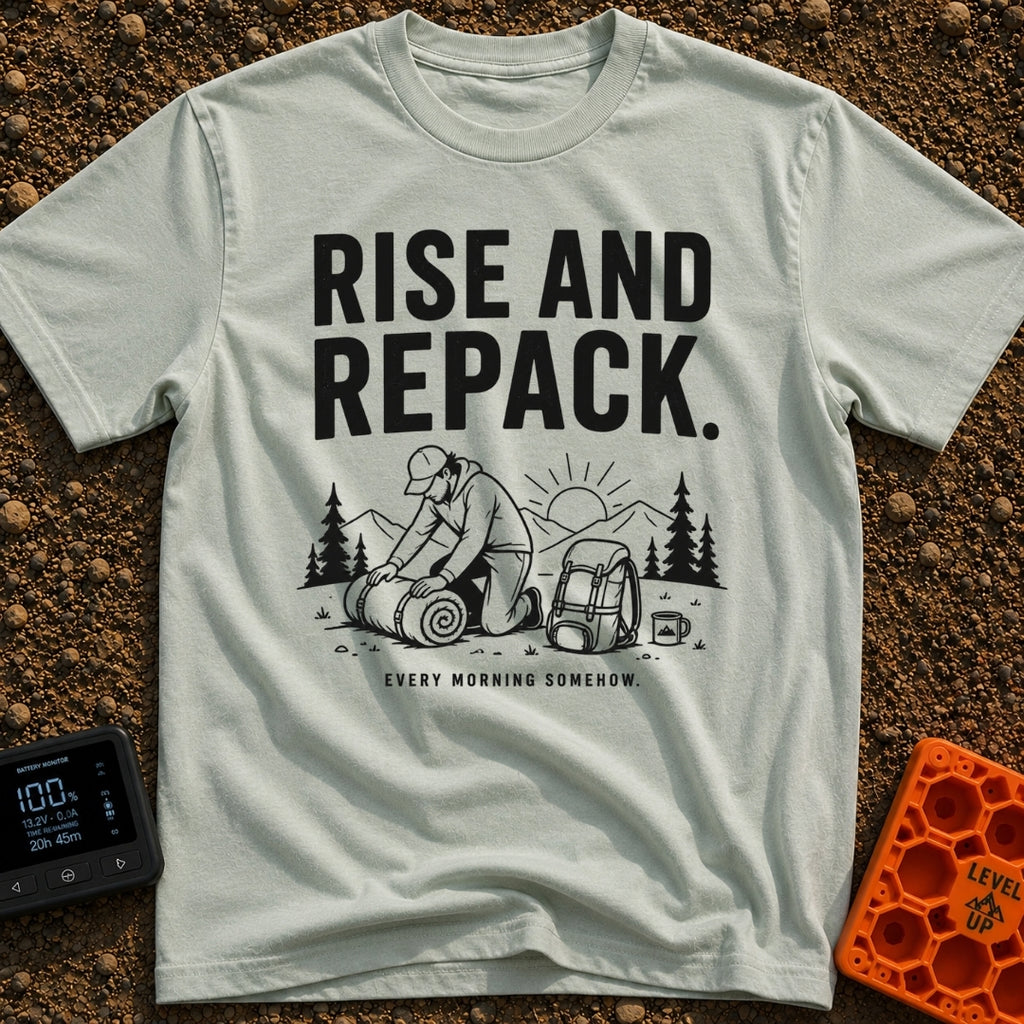 Rise And Repack - T-Shirt in Bay - A black-and-white illustration of a man kneeling to roll up a sleeping bag, with a...