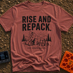 Rise And Repack - T-Shirt in Brick - A black-and-white illustration of a man kneeling to roll up a sleeping bag, with a...