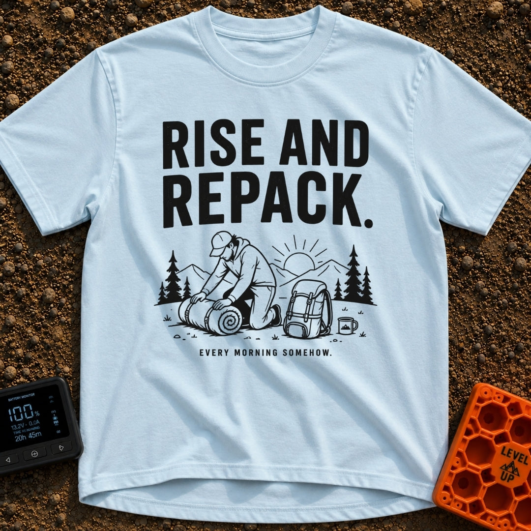 Rise And Repack - T-Shirt in Chambray - A black-and-white illustration of a man kneeling to roll up a sleeping bag, with...