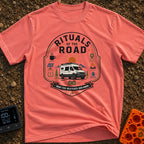 Rituals Of The Road - T-Shirt in Watermelon - A crest-style design featuring a white camper van parked in front of a sun...