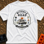 Rituals Of The Road - T-Shirt in White - A crest-style design featuring a white camper van parked in front of a sun and...