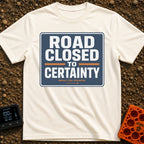 No Certainty Ahead - T-Shirt in Ivory - A graphic designed to look like a blue highway sign with white text that reads...