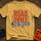 Boundaries Active Peace Protected - T-Shirt in Mustard - A typographic design with large text reading "ROAD OWNED" above...