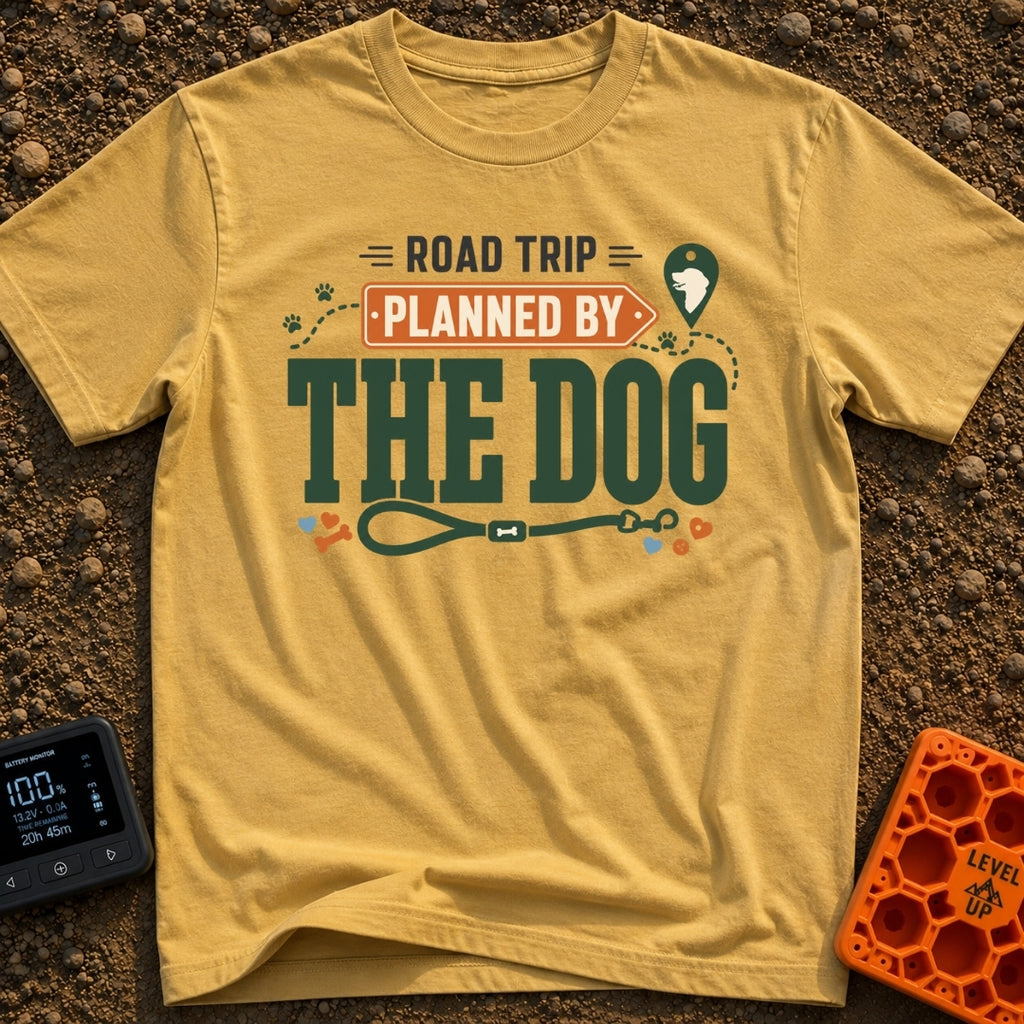 Planned By The Dog - T-Shirt in Mustard - A typographic design reading "ROAD TRIP PLANNED BY THE DOG" with "PLANNED BY"...