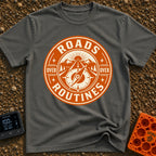 Roads Over Routines - T-Shirt in Pepper - A circular, orange and cream badge design featuring a straight highway leading...
