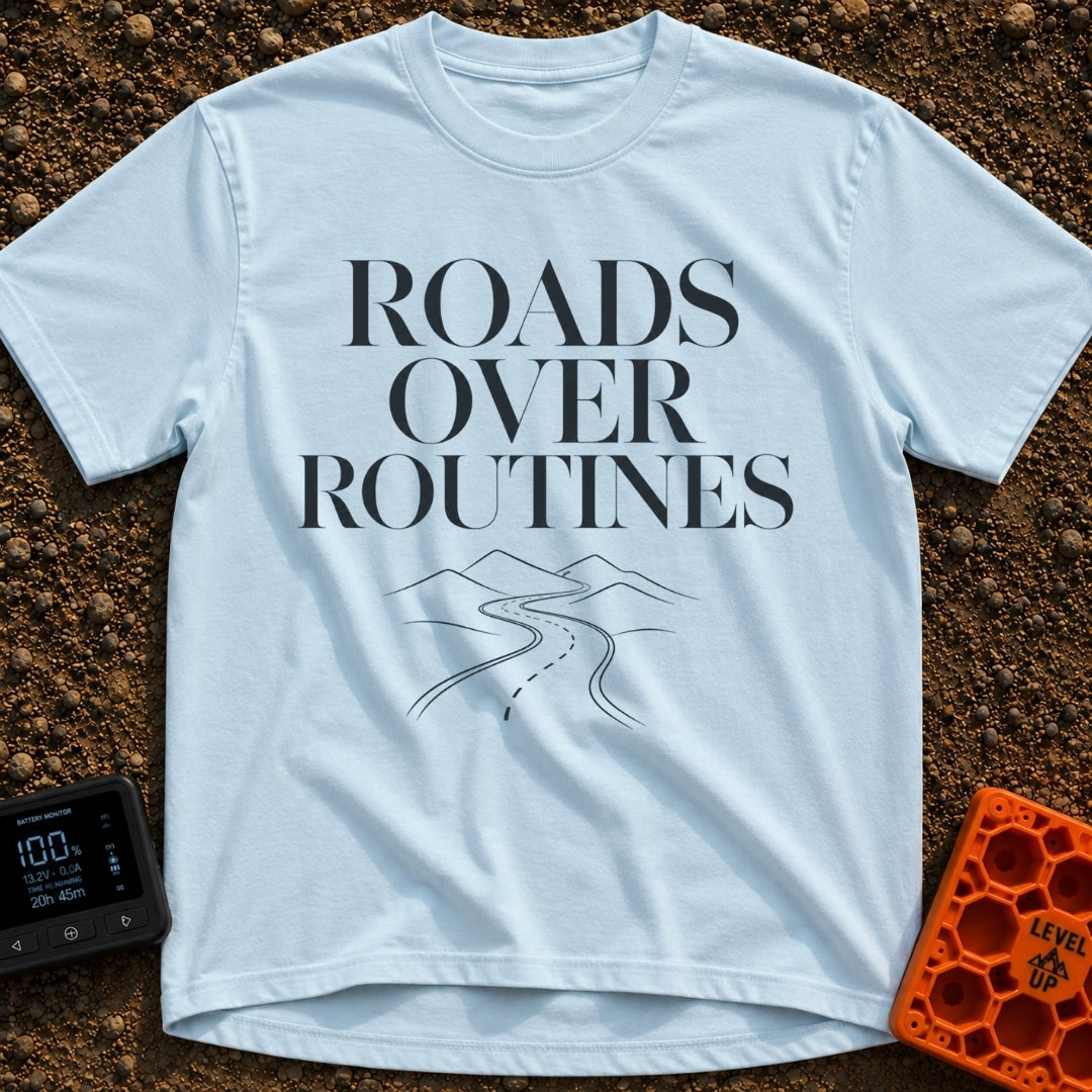 Bypass The Routine - T-Shirt in Chambray - The design features the stacked text "ROADS OVER ROUTINES" in a large, serif...