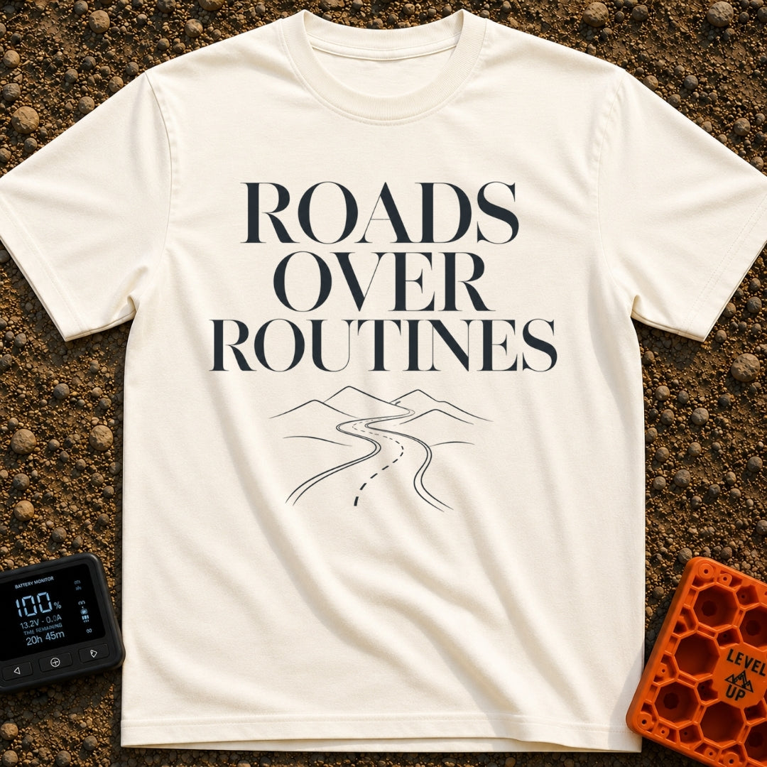 Bypass The Routine - T-Shirt in Ivory - The design features the stacked text "ROADS OVER ROUTINES" in a large, serif...