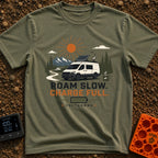 Slow Down Charge Up - T-Shirt in Moss - A white camper van with a tilted roof-mounted solar panel and satellite dish is...