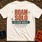 Roam Solo Return Whole - T-Shirt in Ivory - The design features the large text "ROAM SOLO" above "RETURN WHOLE" framed...