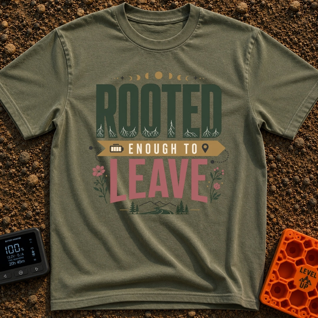 Rooted Yet Roaming - T-Shirt in Moss - A typographic design reading "ROOTED ENOUGH TO LEAVE" with roots drawn inside the...