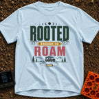 Rooted To Roam - T-Shirt in Chambray - The design features the text "ROOTED ENOUGH TO ROAM" with tree roots growing from...