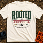 Grounded To Roam - T-Shirt in Ivory - A typographic design reading "ROOTED IN FREEDOM" with roots growing from the...