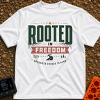Grounded To Roam - T-Shirt in White - A typographic design reading "ROOTED IN FREEDOM" with roots growing from the...