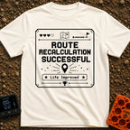 New Route Unlocked - T-Shirt in Ivory - A black and white pixel-art style graphic featuring the text "ROUTE RECALCULATION...