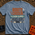 Leash Clipped Peace Kept - T-Shirt in Blue Jean - A typographic design reading "ROUTE CHOSEN", "LEASH CLIPPED" inside a...