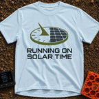 Running On Solar Time - T-Shirt in Chambray - A circular graphic split down the middle, with the left side depicting a...