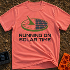 Running On Solar Time - T-Shirt in Watermelon - A circular graphic split down the middle, with the left side depicting a...
