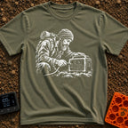 Hungry For Power - T-Shirt in Moss - A black-and-white illustration of a rugged, bearded man wearing a beanie and a heavy...