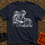Hungry For Power - T-Shirt in Navy - A black-and-white illustration of a rugged, bearded man wearing a beanie and a heavy...