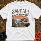Sunrise Sips & Sea - T-Shirt in White - A camper van is parked on a coastal cliff overlooking the ocean at sunrise, with...