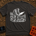 Sasquatch Seeking Signal - T-Shirt in Graphite - A black-and-white illustration of a Sasquatch adjusting a flat satellite...