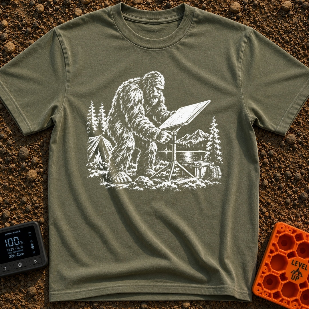 Sasquatch Seeking Signal - T-Shirt in Moss - A black-and-white illustration of a Sasquatch adjusting a flat satellite...