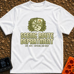 Scenic Route Authority - T-Shirt in White - An olive green crest graphic featuring a compass, mountains, a sun, and a...