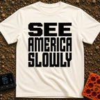 Go Slow, America - T-Shirt in Ivory - Bold, black, block text stacked in three lines reading 'SEE AMERICA SLOWLY' on a...