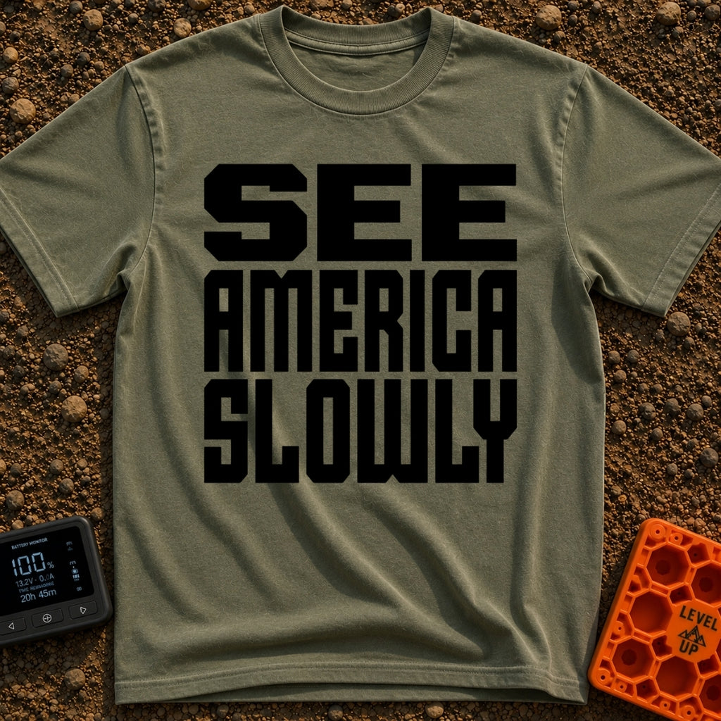 Go Slow, America - T-Shirt in Moss - Bold, black, block text stacked in three lines reading 'SEE AMERICA SLOWLY' on a...