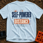 Charged By Distance - T-Shirt in Chambray - A typographic design reading "SELF-POWERED BY DISTANCE" with the word...
