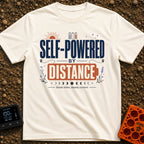 Charged By Distance - T-Shirt in Ivory - A typographic design reading "SELF-POWERED BY DISTANCE" with the word "DISTANCE"...