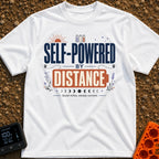 Charged By Distance - T-Shirt in White - A typographic design reading "SELF-POWERED BY DISTANCE" with the word "DISTANCE"...