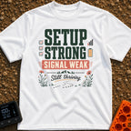Weak Signal Still Thriving - T-Shirt in White - A typographic design reading "SETUP STRONG SIGNAL WEAK Still thriving."...